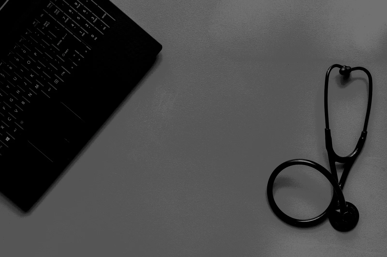 Stethoscope and keyboard representing healthcare technology and advisory work